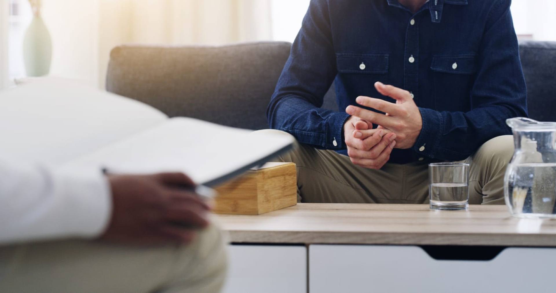 Image of a man sitting, featuring Lakewood Child and Family Counseling and highlighting the topic of suicidal ideation and its impact.